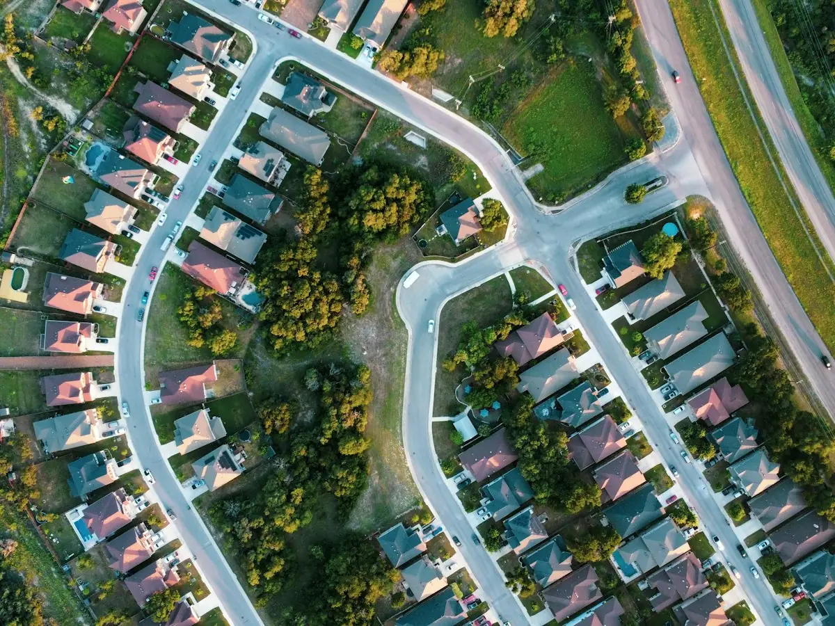 Aerial view of a subdivision with winding streets, cul-de-sacs and rows of similar houses